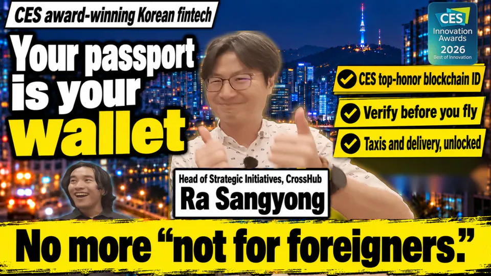 Ra Sangyong, Head of Strategic Initiatives at CrossHub, giving two thumbs up against a Seoul night skyline, with interviewer Kaito Ogasawara laughing in the corner. Text: CES award-winning Korean fintech, Your passport is your wallet, No more “not for foreigners.”, three check labels for a CES top-honor blockchain ID, verifying before you fly, and taxis and delivery, plus the CES Innovation Awards 2026 badge.